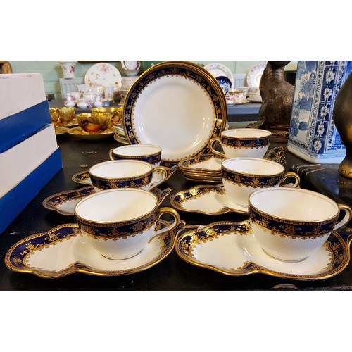 127 - A set of six Aynsley teacups and sandwich saucers,  five further saucers and three side plates,  eac... 