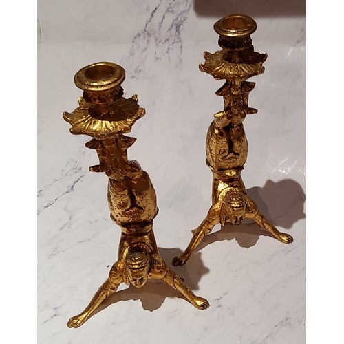 31 - A pair of novelty giltwood candlesticks, as acrobats, 27cm high