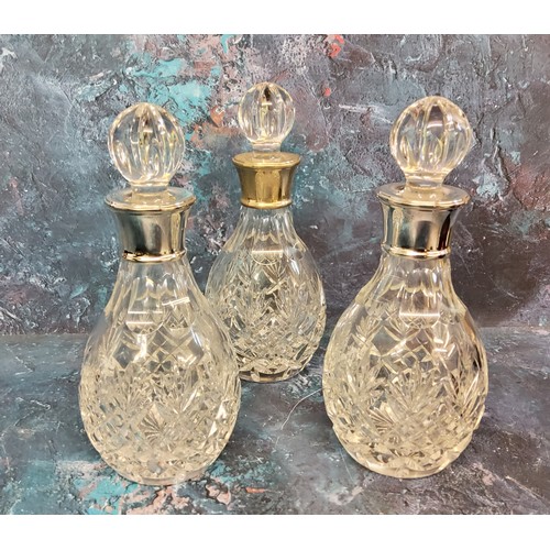 32 - Amended description - a set of three silver mounted small whisky decanter, globular stoppers, 21cm h... 