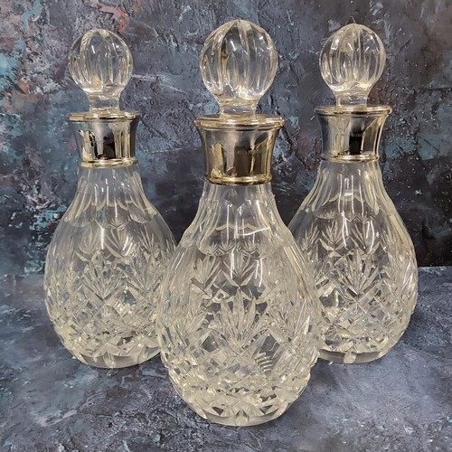 73 - Three silver collared cut glass small decanters, sphere shaped cut glass stopper, James Dixon & ... 