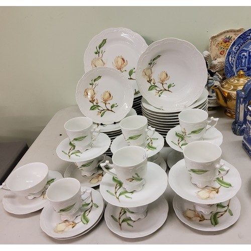 94 - A German Hutschenreuther Victoria dinner and tea service, for twelve, each printed with magnolia flo... 