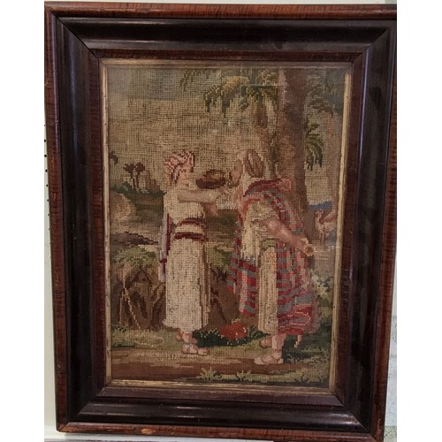 102 - A Victorian woolwork, embroidered with figures taking a drink, possibly Moses, 41cm x 29cm, framed