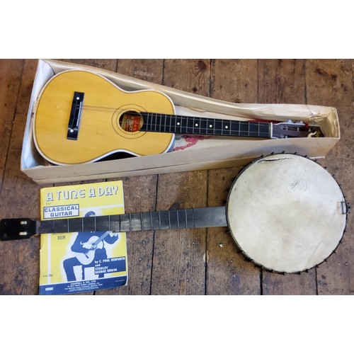 123 - A four-string banjo; Kapok Brand guitar shaped ukulele (2)