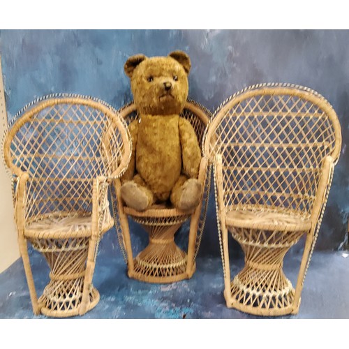 177 - Amended description - three wicker doll's wicker chairs, 40cm high;  a jointed teddy bear, straw-fil... 