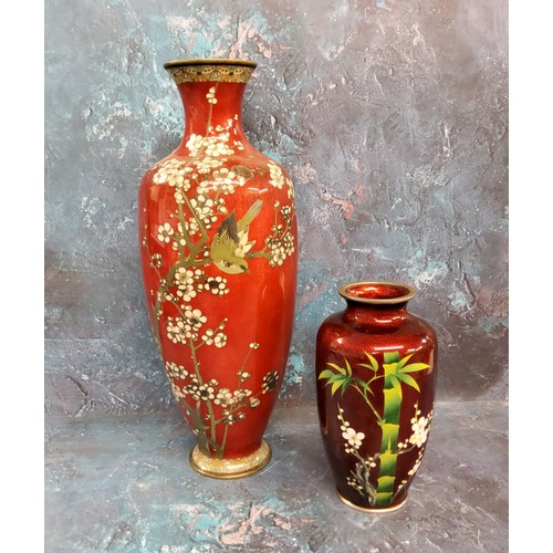 199 - A Japanese cloisonne ovoid vase, decorated with bamboo and blossoming prunus branches, on a red grou... 