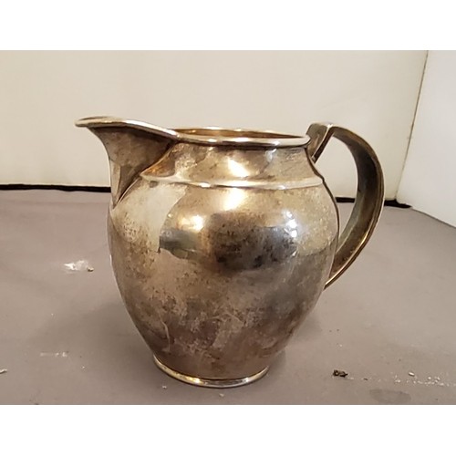 300 - A silver ovoid cream jug, 9cm high, Birmingham 1908, oz