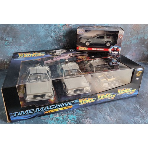 748 - A Welly Back to the Future Time Machine Trilogy pack 1:24 scale, comprising of Doloreans from Back t... 