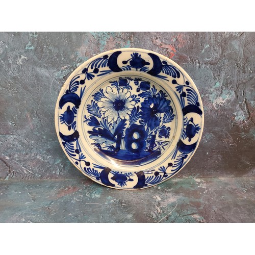 35A - An 18th century Dutch Delft plate, decorated in underglazed blue with stylised flowers and fence, 24... 