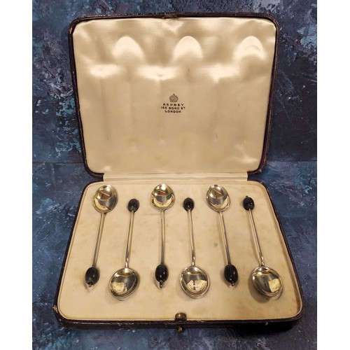 53 - A set of six silver and enamelled coffee spoons, the backs enamelled in blue, bean terminals, Henry ... 