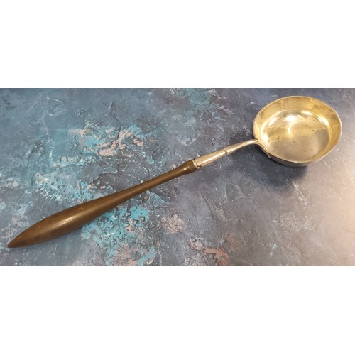 125 - A 19th century silver coloured metal  toddy ladle, turned fruit wood handle, 39cm high, c.1780 - 182... 