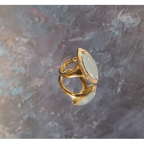 170 - A 9ct gold navette shaped ring, set with a central navette shape pale blue stone, bordered by diamon... 