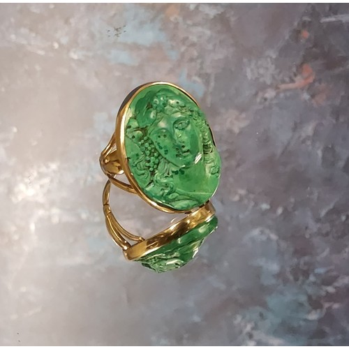 181 - A 9ct gold green lava cameo ring, the oval lava cameo depicting a Greek maiden, 26 x 20mm, size M 12... 