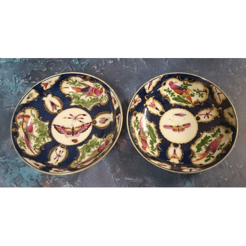 345 - A pair of Worcester blue scale  teacups and saucers,   painted with alternating cartouche and vase s... 