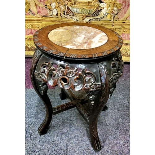 435 - A 19th century Chinese hardwood jardiniere stand, circular top inset with a well figured marble pane... 