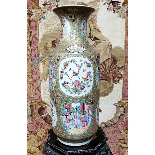 396 - A large 19th century Cantonese Famille Rose vase, the cartouche panels decorated with figures social... 