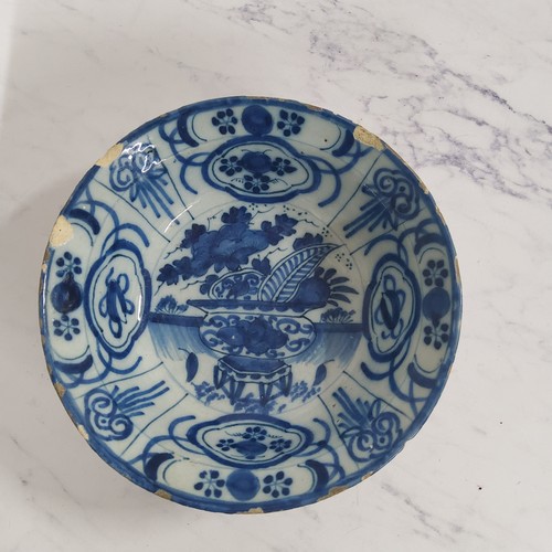 297 - An 18th century English Delft bowl, in the manner of Dutch kraak, the centre with jardiniere and fol... 