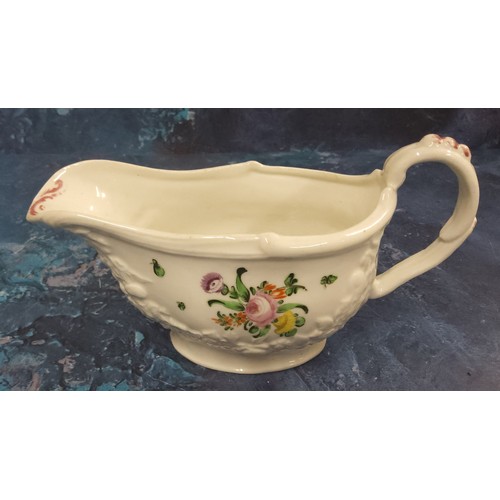 317 - A good Bristol sauceboat,  with moulded floral chains,  painted with colourful flowers, picked out i... 