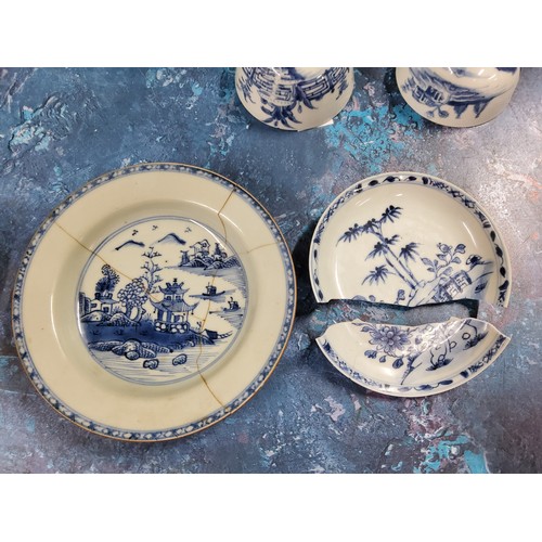 399 - Three Chinese circular dished plates, each decorated in blue and white with pagodas, pine trees and ... 