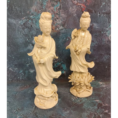 403 - Four 19th century Blanc de Chine figure, Guanyin, standing holding a lotus, 22cm high;  another, sim... 