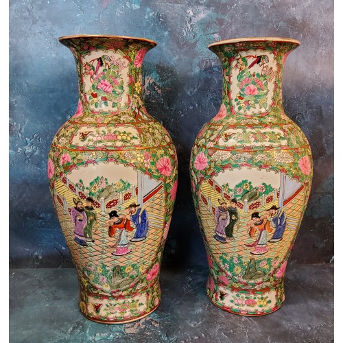 406 - A pair of Canton Famille Rose vases, polychrome decorated with a border of chrysanthemums, roses, bi... 