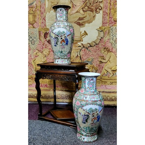 406 - A pair of Canton Famille Rose vases, polychrome decorated with a border of chrysanthemums, roses, bi... 