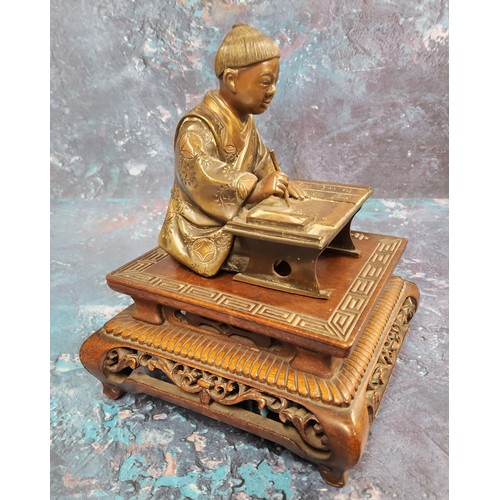 421 - Japanese School, Meiji period,  dark patinated bronze, Scholar, seated at desk, 10cm high, hardwood ... 