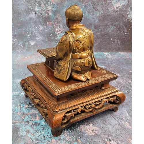 421 - Japanese School, Meiji period,  dark patinated bronze, Scholar, seated at desk, 10cm high, hardwood ... 