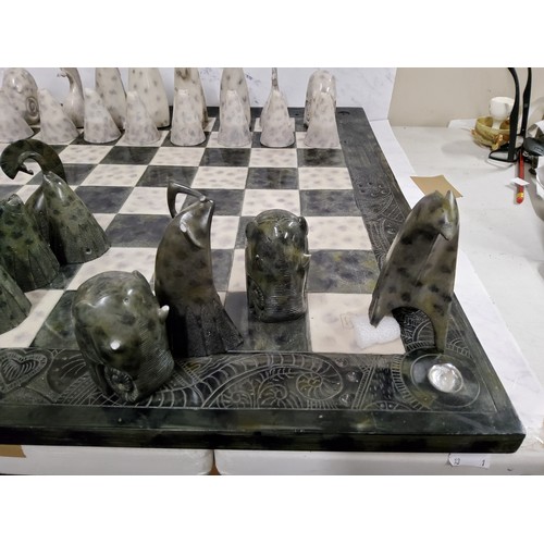 434 - Govinder Nazran (1964-2008, British), a chess set, each piece as a stylised animal, the board 62cm s... 