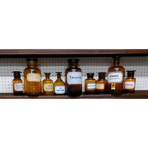 448 - A collection of nine early 20th century apothecary bottles