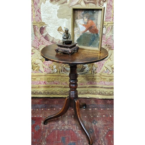 487 - A George III oak tripod occasional table, circular top, tilting on ring turned column, scroll legs, ... 