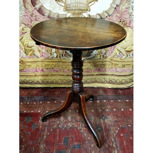 487 - A George III oak tripod occasional table, circular top, tilting on ring turned column, scroll legs, ... 