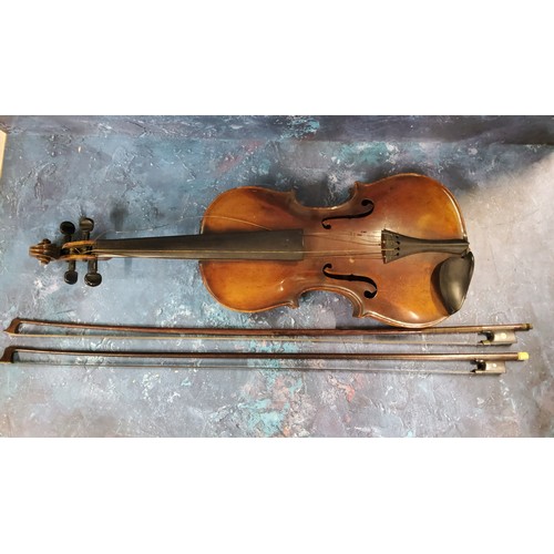 555 - A late 19th century violin, two piece back,  stamped Stainer,  length 37cm long, c.1890;  two bows