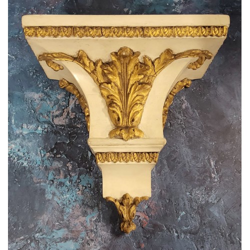 470 - A 19th century painted oak wall bracket, applied with gilt scrolling leaves, leafy borders, 29cm hig... 