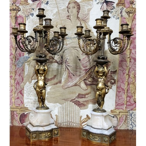 670 - A good pair of 19th century gilt bronze and alabaster five branch, six light candelabras, the ornate... 