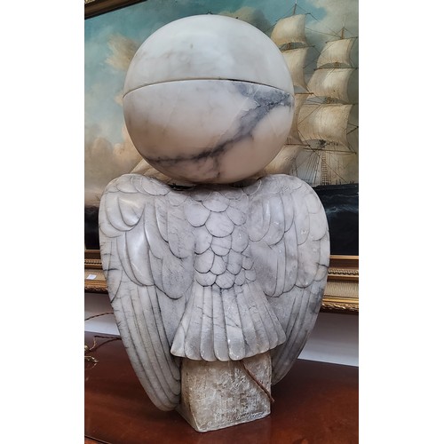 671 - An impressive Art Deco Italian alabaster table lamp in the form of a golden eagle, surmounted with a... 