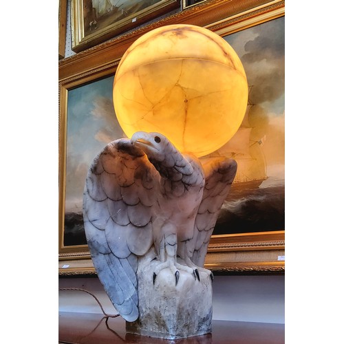 671 - An impressive Art Deco Italian alabaster table lamp in the form of a golden eagle, surmounted with a... 