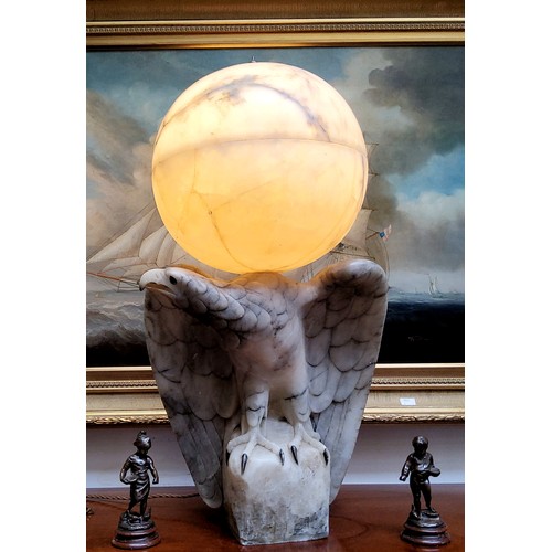 671 - An impressive Art Deco Italian alabaster table lamp in the form of a golden eagle, surmounted with a... 