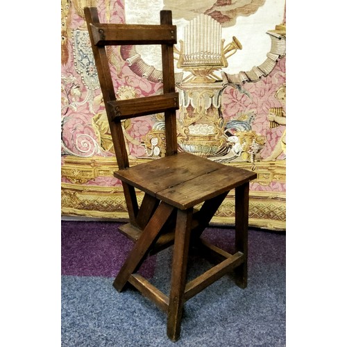 565 - An early 20th century metamorphic library chair, the hinged back splat folds to make a set of librar... 