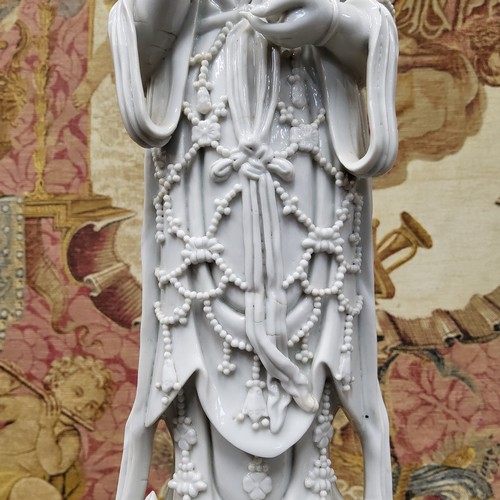 390 - An 18th/19th century Chinese blanc de chine figure, of Guanyin, the deity modelled standing wearing ... 