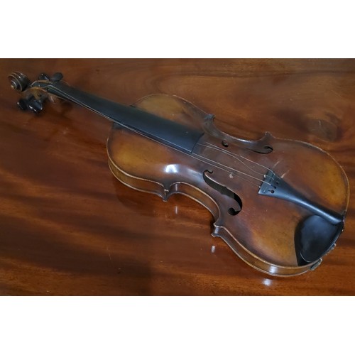 555 - A late 19th century violin, two piece back,  stamped Stainer,  length 37cm long, c.1890;  two bows