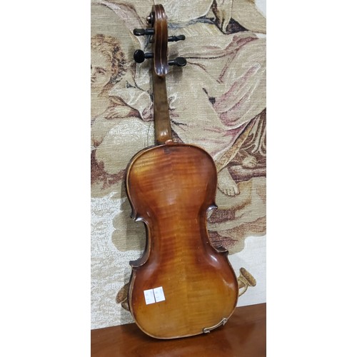 555 - A late 19th century violin, two piece back,  stamped Stainer,  length 37cm long, c.1890;  two bows