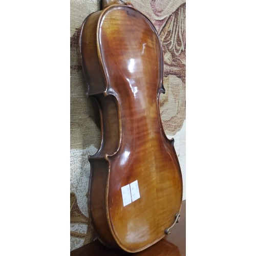 555 - A late 19th century violin, two piece back,  stamped Stainer,  length 37cm long, c.1890;  two bows