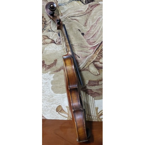 555 - A late 19th century violin, two piece back,  stamped Stainer,  length 37cm long, c.1890;  two bows