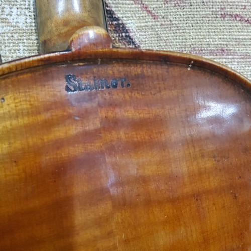 555 - A late 19th century violin, two piece back,  stamped Stainer,  length 37cm long, c.1890;  two bows