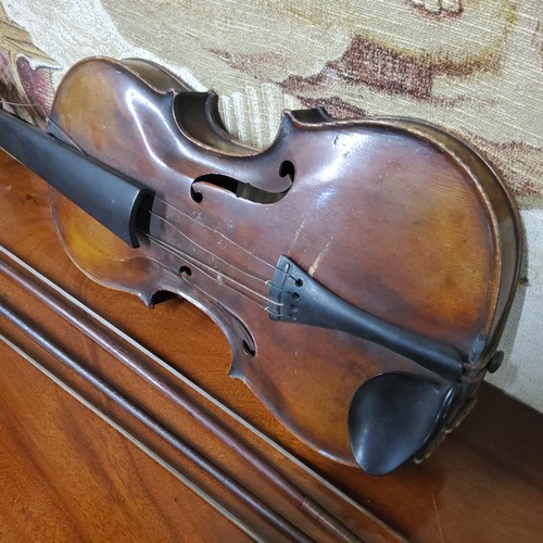 555 - A late 19th century violin, two piece back,  stamped Stainer,  length 37cm long, c.1890;  two bows