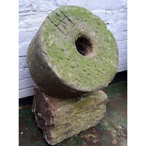 776 - A Derbyshire gritstone millstone engraved 'HS' to one side, the othero 'Malc's Den'; a dressed solid... 