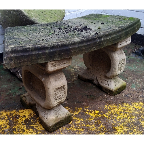 777 - A reconstituted gritstone bowed garden seat.