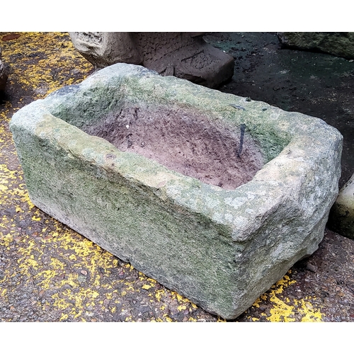 779 - A Derbyshire gritstone trough, deeply carved-out, with drainage hole to base.