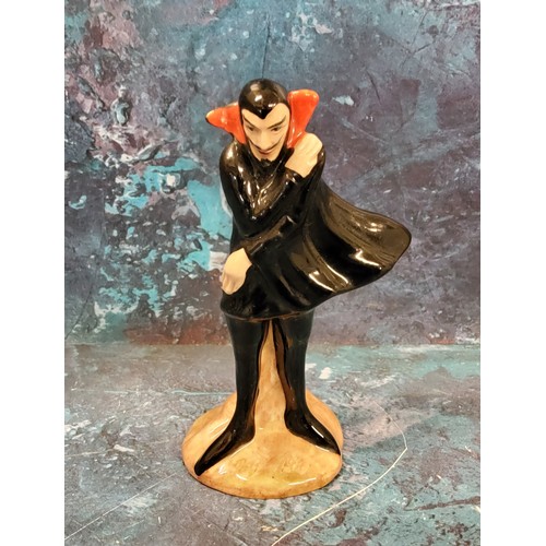 2 - A Carlton Ware Mephisto Series figure, he stands, wearing a black cape, 11cm high, printed mark