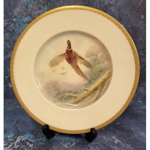 6 - A Minton's circular plate, painted by J E Dean, signed, Pheasant, gilt banded border, 23cm diam, pri... 